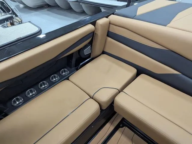 Slide: The Image of 2025 Axis Wake Research A225 interior with tan and black seating, cup holders visible. - 9