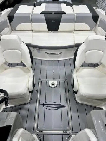 Slide: The Image of 2024 Chaparral 21 SSi boat interior with white seating and sleek gray flooring. - 7