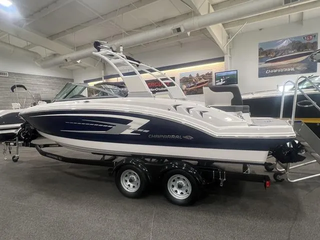 Slide: The Image of 2024 Chaparral 23 SSi boat displayed indoors on a trailer. - 1