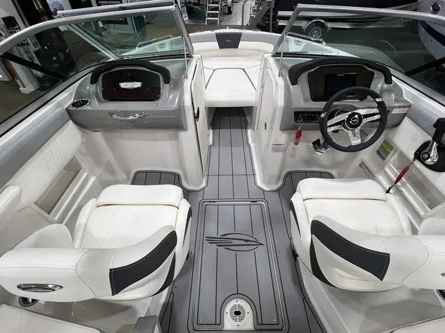 Slide: The Image of 2024 Chaparral 23 SSi boat interior with modern seating and steering wheel. - 10