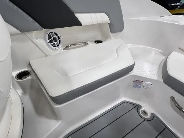 Slide: The Image of 2024 Chaparral 23 SSi boat interior with white seating and speaker detail. - 12