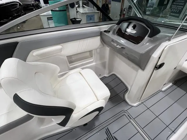 Slide: The Image of 2024 Chaparral 23 SSi boat interior with sleek helm and comfortable seating. - 14