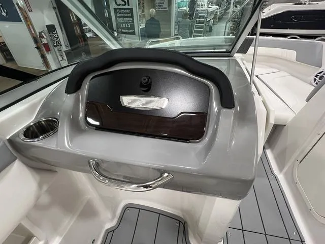 Slide: The Image of 2024 Chaparral 23 SSi boat interior, featuring sleek dashboard and seating area. - 15