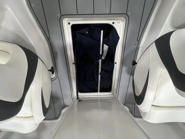 Slide: The Image of 2024 Chaparral 23 SSi boat interior storage compartment with seats. - 16