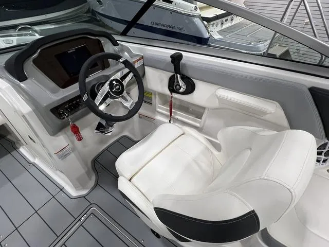 Slide: The Image of 2024 Chaparral 23 SSi boat interior with steering wheel and captain's seat. - 17