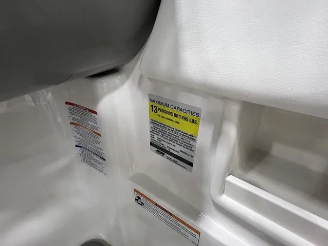 Slide: The Image of 2024 Chaparral 23 SSi boat capacity label, maximum 13 persons or 1765 lbs. - 18