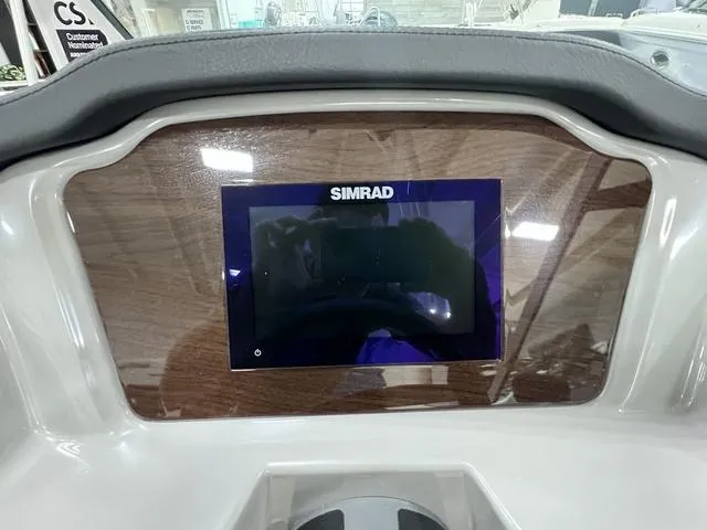 Slide: The Image of 2024 Chaparral 23 SSi dashboard featuring a Simrad display. - 19