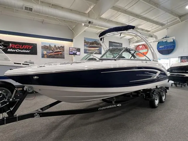 Slide: The Image of 2024 Chaparral 23 SSi boat displayed indoors on a trailer. - 2