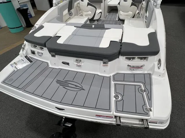 Slide: The Image of 2024 Chaparral 23 SSi boat interior with gray and white seating and deck. - 4