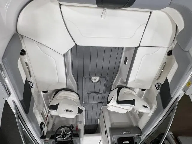 Slide: The Image of 2024 Chaparral 23 SSi boat interior with white seating and gray flooring. - 8
