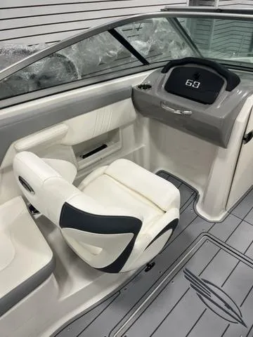Slide: The Image of 2025 Chaparral 23 SSi boat interior with modern dashboard and comfortable seating. - 13