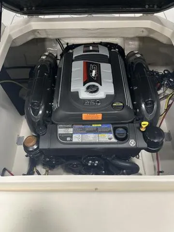 Slide: The Image of Engine compartment of a 2025 Chaparral 23 SSi boat, featuring a powerful 4.5L engine. - 14