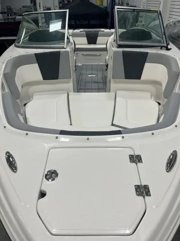 Slide: The Image of 2025 Chaparral 23 SSi boat on trailer in showroom, rear view. - 4