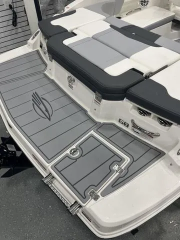 Slide: The Image of 2025 Chaparral 23 SSi boat in showroom, rear view with propeller visible. - 6