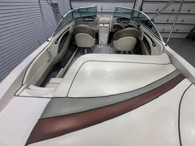 Slide: The Image of 2005 Sea Ray 200 Signature boat interior with beige seating and sleek design. - 10