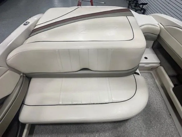 Slide: The Image of 2005 Sea Ray 200 Signature boat interior seating, beige upholstery with brown accents. - 13