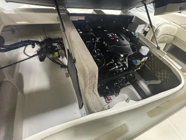 Slide: The Image of Engine compartment of a 2005 Sea Ray 200 Signature boat, showcasing the engine and interior layout. - 15