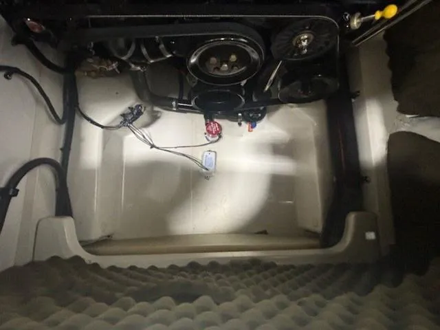 Slide: The Image of Engine compartment of a 2005 Sea Ray 200 Signature boat, showing mechanical components. - 16