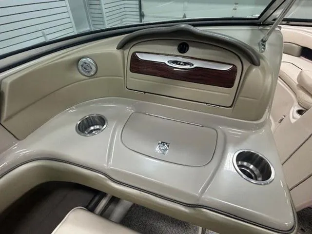 Slide: The Image of Interior of a 2005 Sea Ray 200 Signature boat, featuring cup holders and storage compartments. - 18