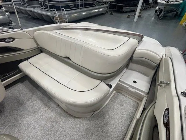 Slide: The Image of 2005 Sea Ray 200 Signature boat interior with beige seating and carpeted flooring. - 21