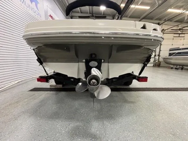 Slide: The Image of 2005 Sea Ray 200 Signature boat in a showroom, rear view showing propeller and hull. - 24