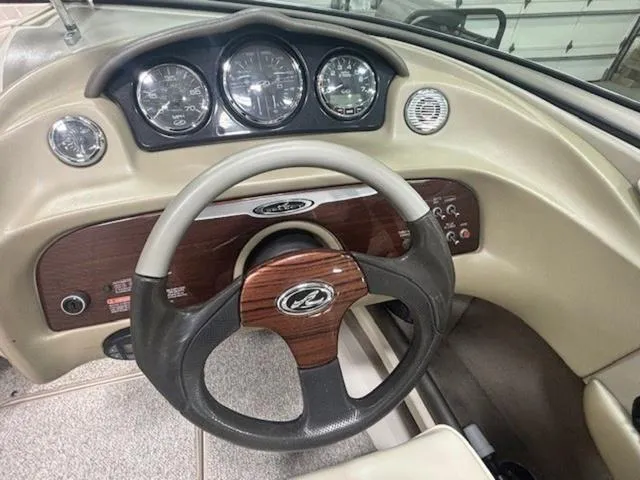 Slide: The Image of 2005 Sea Ray 200 Signature boat dashboard with steering wheel and gauges. - 6