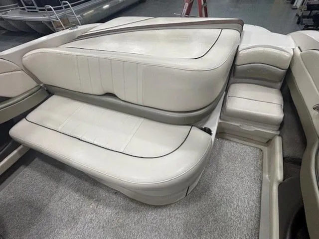 Slide: The Image of 2005 Sea Ray 200 Signature boat interior seating, featuring white cushioned seats. - 9