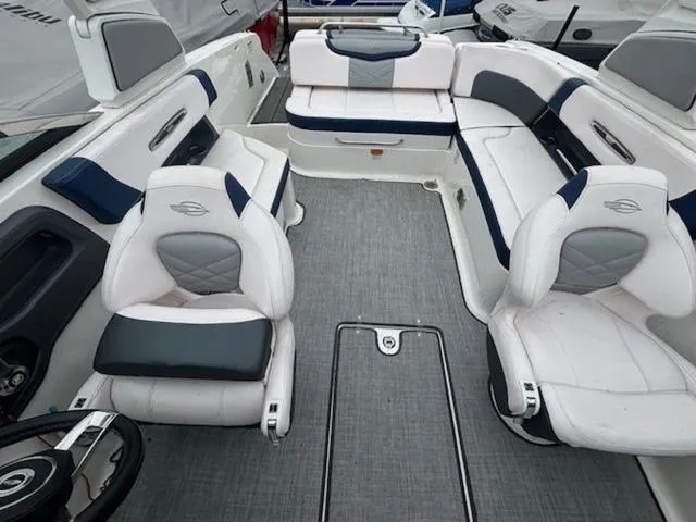 Slide: The Image of 2019 Chaparral 277 SSX boat interior with white and gray seating, modern design. - 23