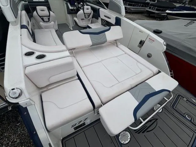 Slide: The Image of 2019 Chaparral 277 SSX boat interior with white seating and cup holders. - 24