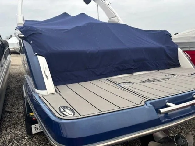 Slide: The Image of 2019 Chaparral 277 SSX boat with blue cover, rear view on trailer. - 27