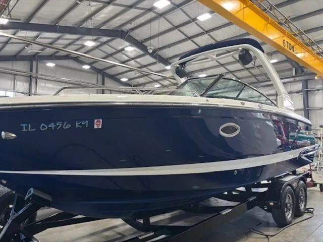 Slide: The Image of 2019 Chaparral 277 SSX boat in a warehouse, on a trailer, under bright lighting. - 3