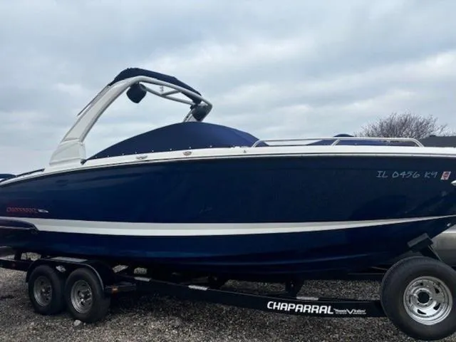 Slide: The Image of 2019 Chaparral 277 SSX boat on trailer, blue and white design, parked outdoors. - 38