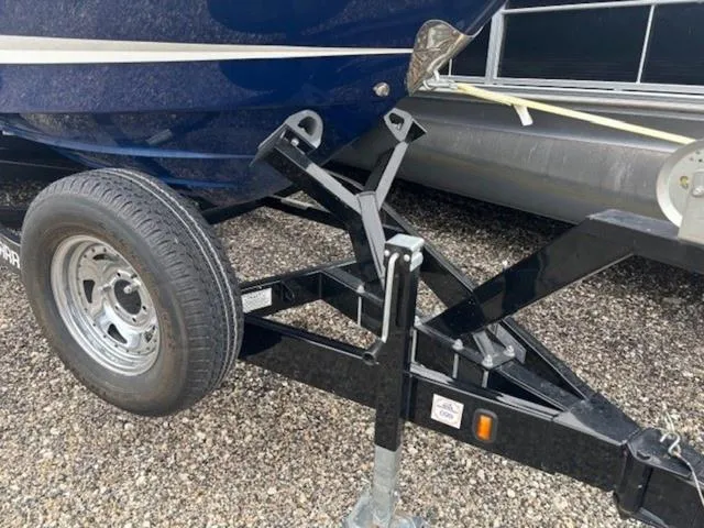 Slide: The Image of 2019 Chaparral 277 SSX boat trailer with black frame and wheel on gravel. - 39