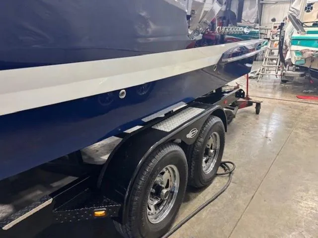 Slide: The Image of 2019 Chaparral 277 SSX boat on trailer in a workshop setting. - 4