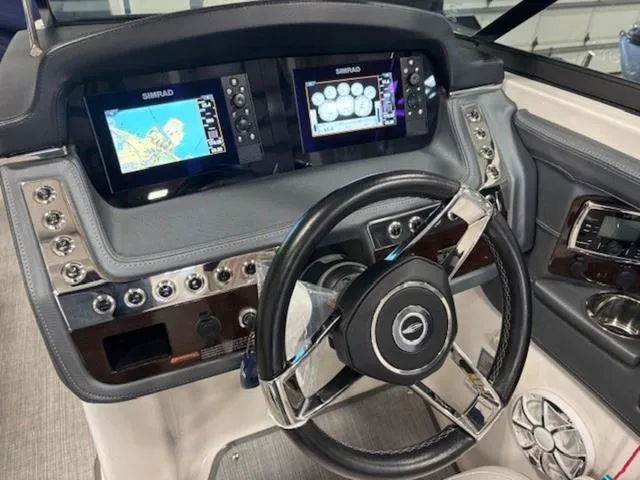 Slide: The Image of 2019 Chaparral 277 SSX boat dashboard with dual Simrad displays and modern steering wheel. - 46