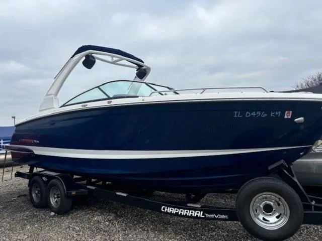 Slide: The Image of 2019 Chaparral 277 SSX boat on trailer, blue and white design, overcast sky. - 5