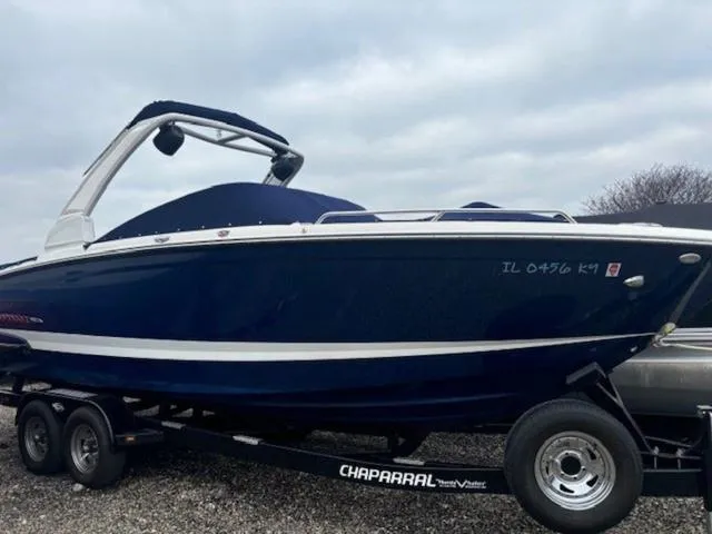 Slide: The Image of 2019 Chaparral 277 SSX boat on trailer, blue hull, overcast sky background. - 7
