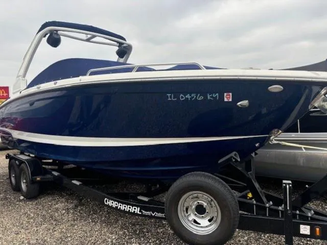 Slide: The Image of 2019 Chaparral 277 SSX boat on trailer, blue exterior, parked outdoors. - 8