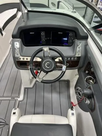 Slide: The Image of 2022 Chaparral 28 Surf boat cockpit with modern steering and control panel. - 13