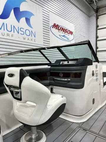 Slide: The Image of 2022 Chaparral 28 Surf boat interior with captain's chair and control panel. - 14