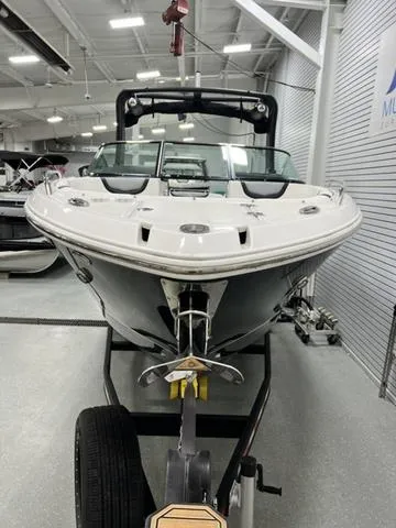 Slide: The Image of 2022 Chaparral 28 Surf boat in showroom, front view, on trailer. - 3