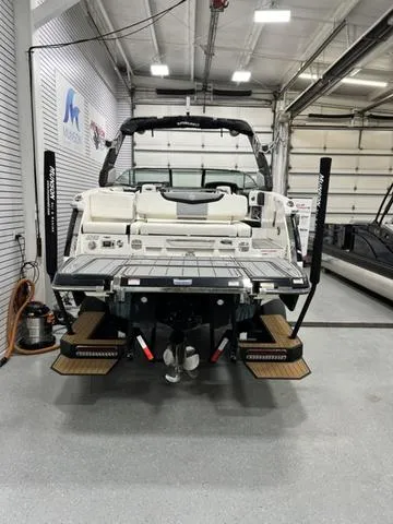 Slide: The Image of 2022 Chaparral 28 Surf boat in a showroom, rear view. - 7