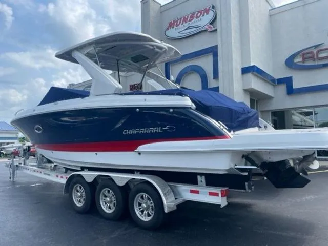 Slide: The Image of 2023 Chaparral 307 SSX boat on a trailer outside a dealership. - 3