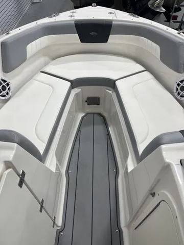 Slide: The Image of 2022 Chaparral 23 SSi boat interior with gray and white seating. - 12