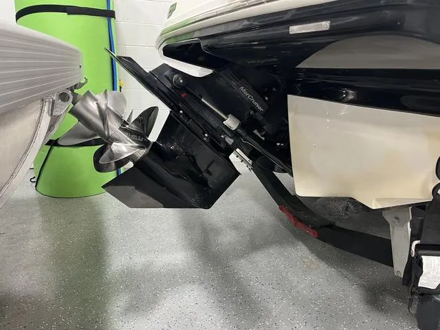 Slide: The Image of 2022 Chaparral 23 SSi boat propeller and stern detail in a garage setting. - 2