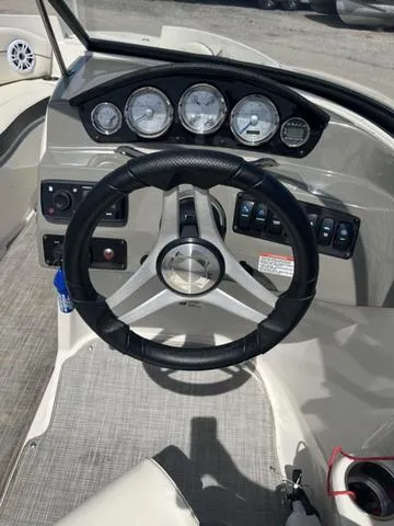 Slide: The Image of 2020 Stingray 208LR boat dashboard with steering wheel and gauges. - 11