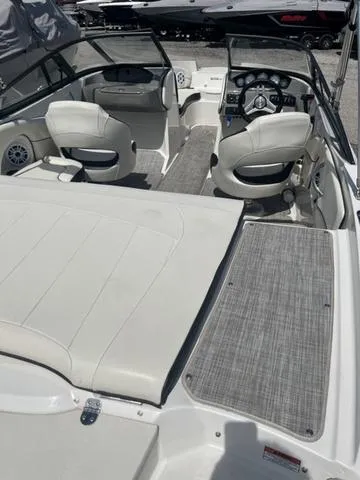 Slide: The Image of 2020 Stingray 208LR boat interior with white seating and modern dashboard. - 6