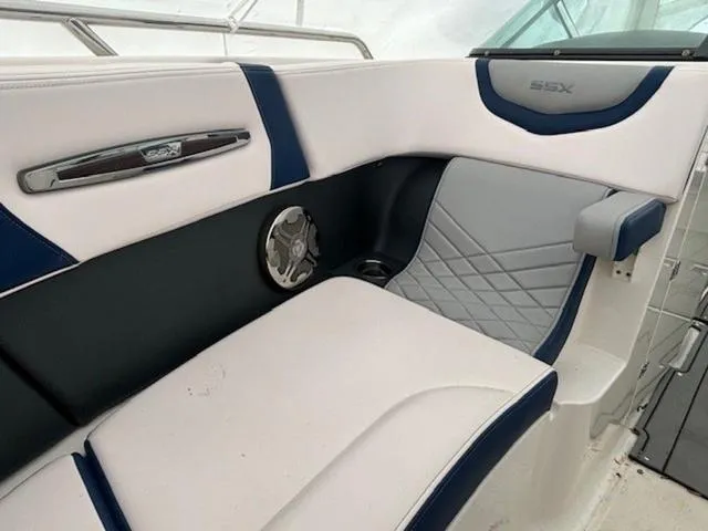Slide: The Image of 2020 Chaparral 257 SSX boat interior with white and blue seating, speaker, and stylish design. - 11