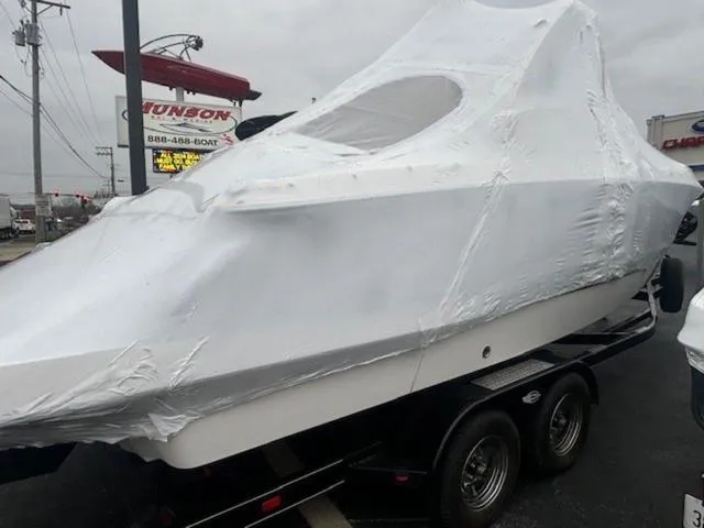 Slide: The Image of 2020 Chaparral 257 SSX boat covered in protective wrap on a trailer. - 18