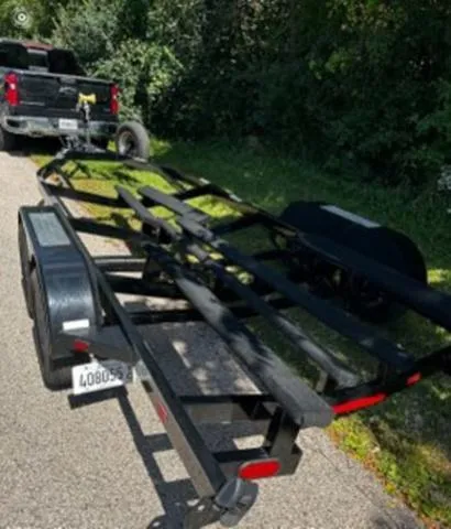 Slide: The Image of Trailer for 2020 Chaparral 257 SSX parked on roadside near a black truck. - 21